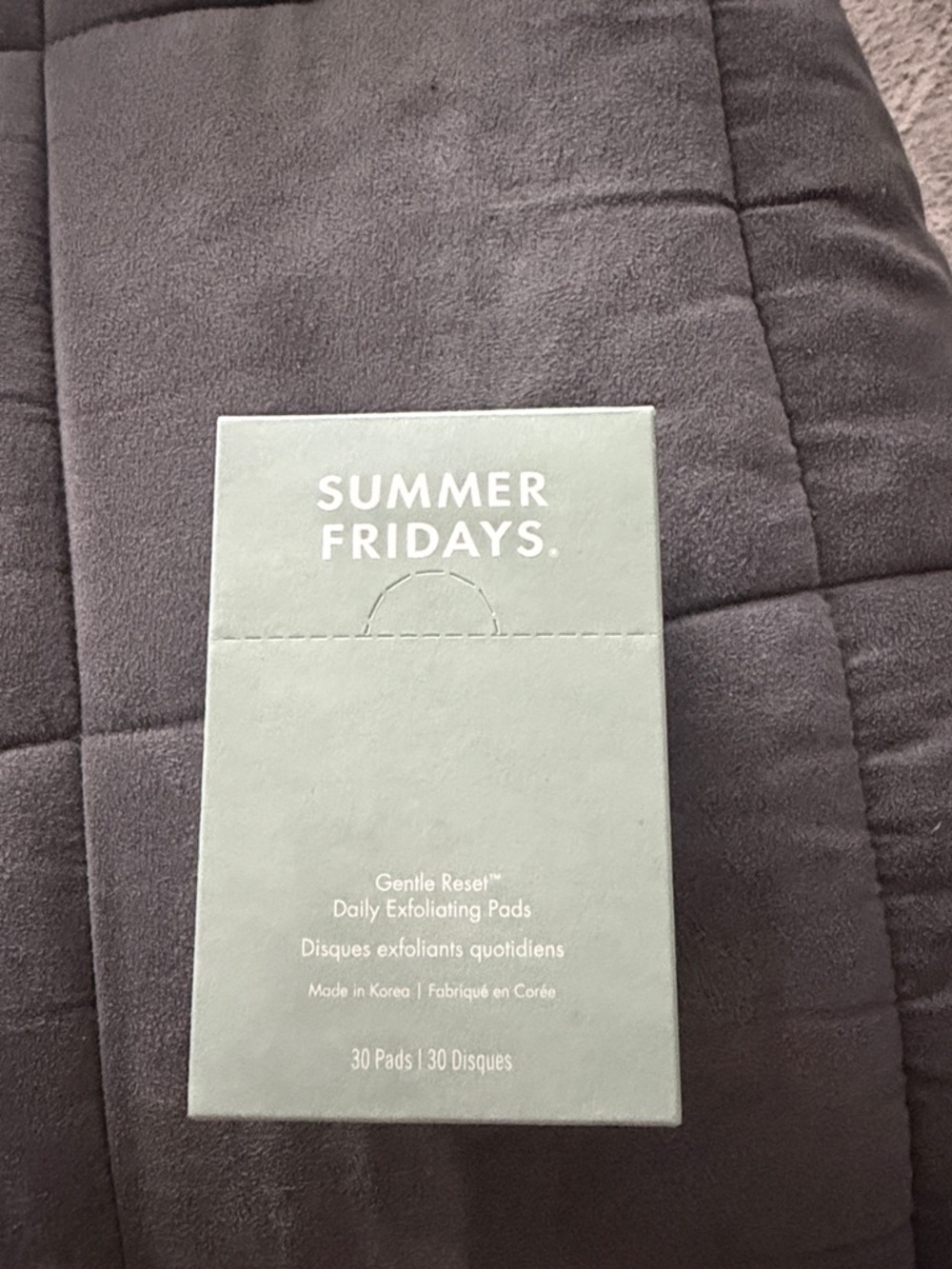Summer Fridays box in sage green with gray background